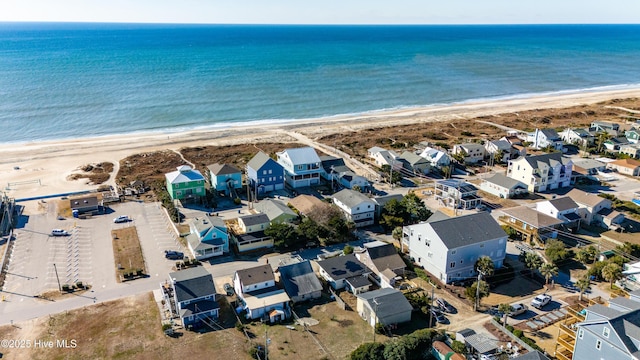 birds eye view of property with a beach view and a water view