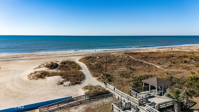 birds eye view of property featuring a view of the beach and a water view