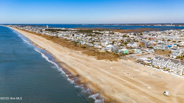 aerial view with a water view and a beach view