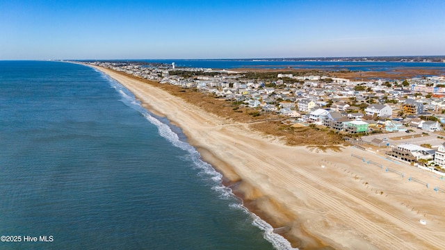 birds eye view of property with a beach view and a water view