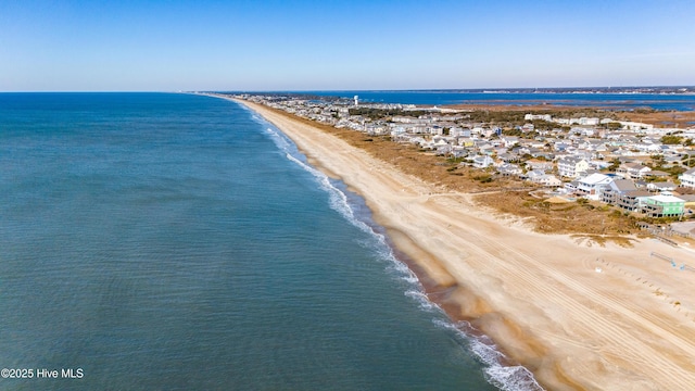 drone / aerial view featuring a water view and a view of the beach