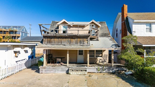 view of front of home with a balcony and a patio