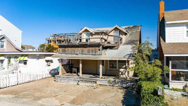 view of front of property with a patio and a balcony