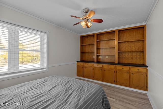 unfurnished bedroom featuring crown molding, ceiling fan, and light wood-type flooring