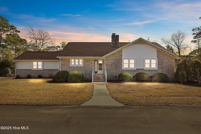 ranch-style house with a lawn