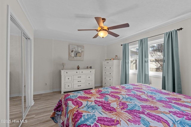 bedroom with light hardwood / wood-style flooring, ornamental molding, a closet, and ceiling fan