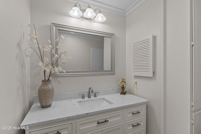 bathroom with ornamental molding and vanity