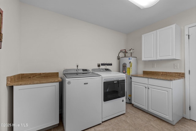 clothes washing area with water heater, separate washer and dryer, and cabinets