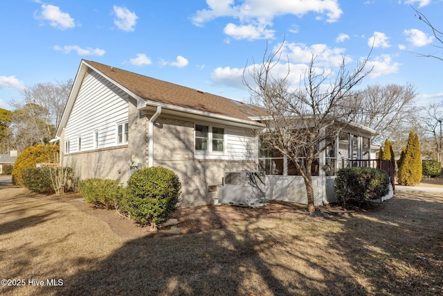 view of side of property featuring a sunroom