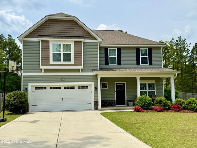 451 Gretchen Rd, West End, NC 27376 - craftsman-style house featuring covered porch, concrete driveway, a garage, fence, and a front yard