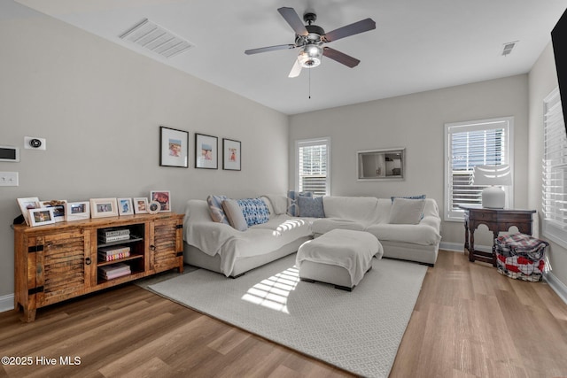 living room featuring hardwood / wood-style flooring, ceiling fan, and a wealth of natural light