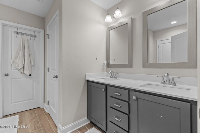 451 Gretchen Rd, West End, NC 27376 - bathroom with baseboards, wood finish floors, a sink, and double vanity