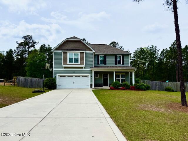 451 Gretchen Rd, West End, NC 27376 - view of front of house featuring a garage, driveway, a porch, and fence