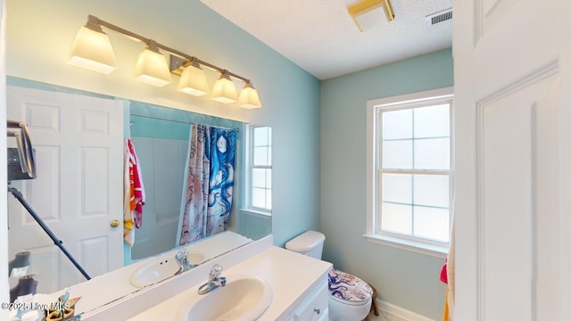 bathroom featuring vanity, a textured ceiling, and toilet