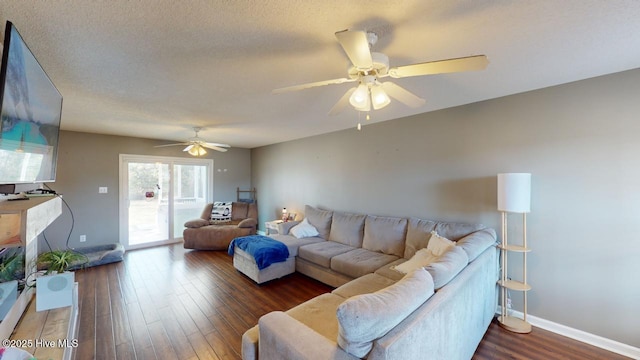 living room featuring ceiling fan, dark hardwood / wood-style flooring, and a textured ceiling