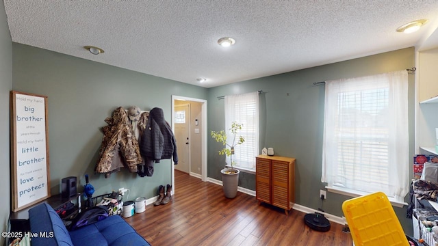 interior space with dark hardwood / wood-style flooring and a textured ceiling