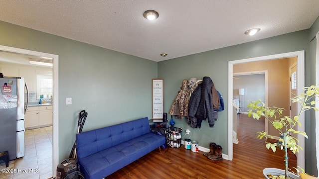 living area with light hardwood / wood-style floors and a textured ceiling