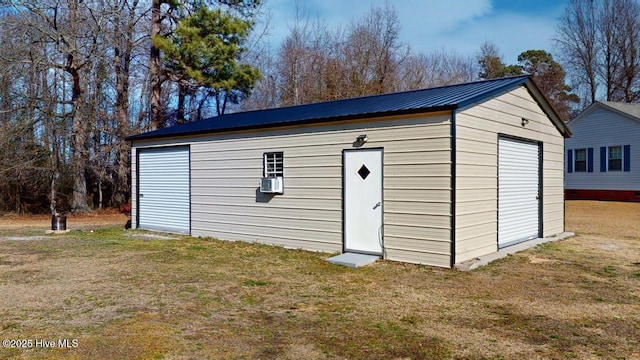 view of outdoor structure featuring a garage and a yard