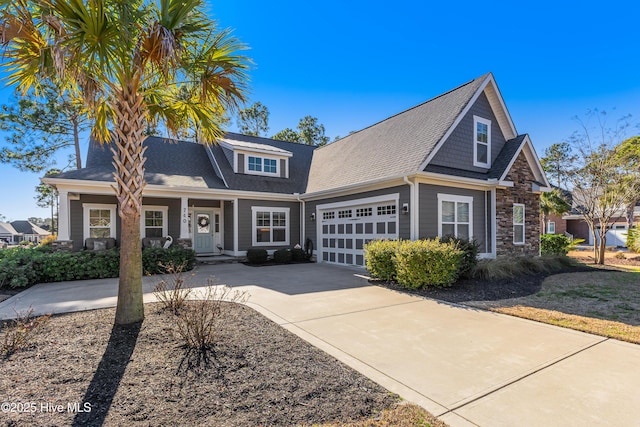 craftsman inspired home with a garage and a porch