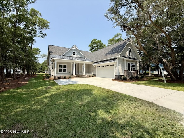 3387 Four Water Ln SW, Supply, NC 28462 - view of front of house with a standing seam roof, a garage, covered porch, concrete driveway, and metal roof