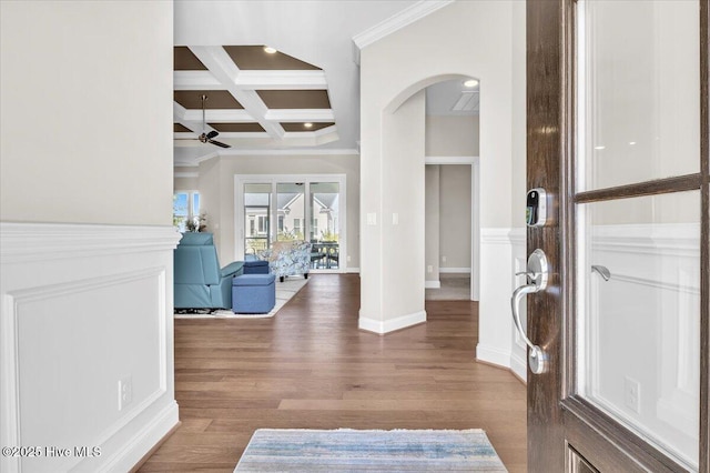 foyer with coffered ceiling, beam ceiling, wood-type flooring, and crown molding