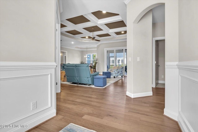 hallway featuring coffered ceiling, crown molding, beam ceiling, and light hardwood / wood-style floors