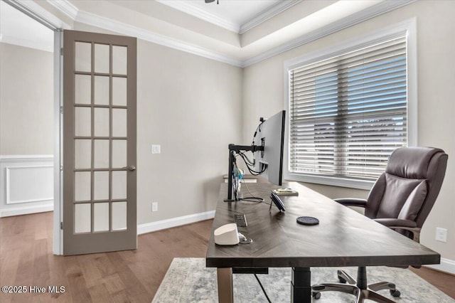 office featuring crown molding, a tray ceiling, and hardwood / wood-style flooring