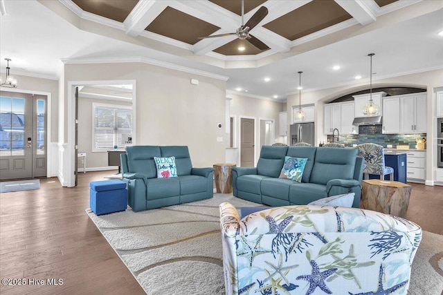 living room with beamed ceiling, coffered ceiling, dark hardwood / wood-style floors, and crown molding