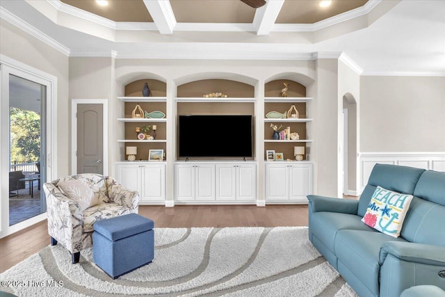 living room featuring coffered ceiling, light hardwood / wood-style flooring, ornamental molding, and beamed ceiling