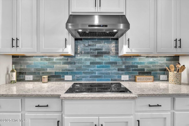 kitchen with white cabinetry, black electric stovetop, and range hood