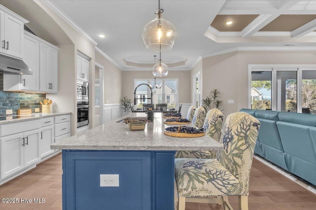 kitchen featuring sink and a large island with sink