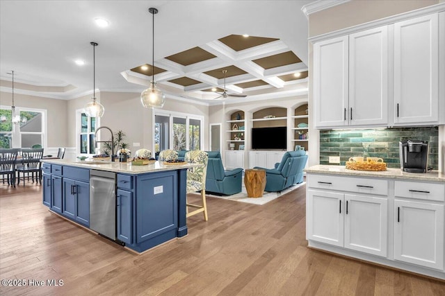 kitchen featuring pendant lighting, a kitchen island with sink, dishwasher, and white cabinets