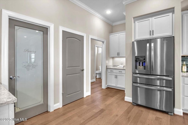 kitchen with white cabinetry, crown molding, light hardwood / wood-style floors, stainless steel refrigerator with ice dispenser, and light stone countertops