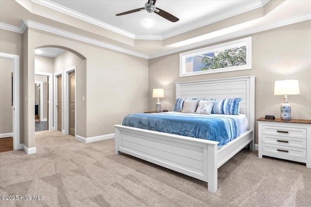 bedroom featuring ceiling fan, ornamental molding, a raised ceiling, and light carpet