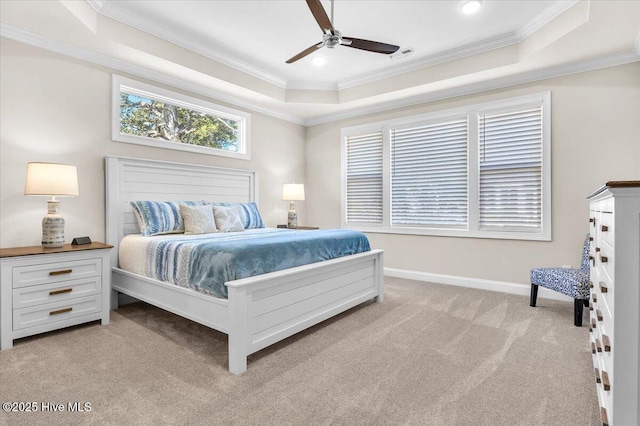 carpeted bedroom featuring crown molding, a tray ceiling, and ceiling fan