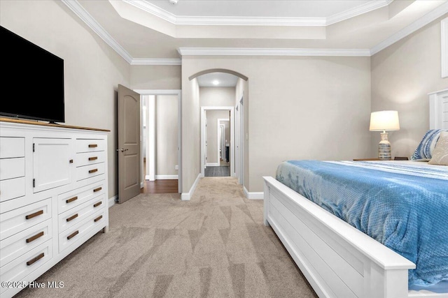 bedroom with a raised ceiling, ornamental molding, and light carpet