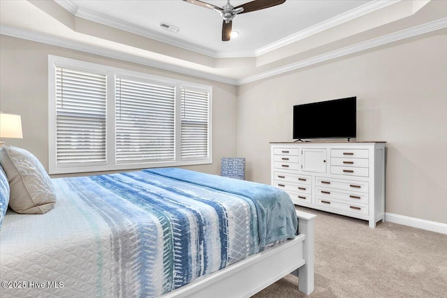 bedroom with crown molding, light colored carpet, a raised ceiling, and ceiling fan