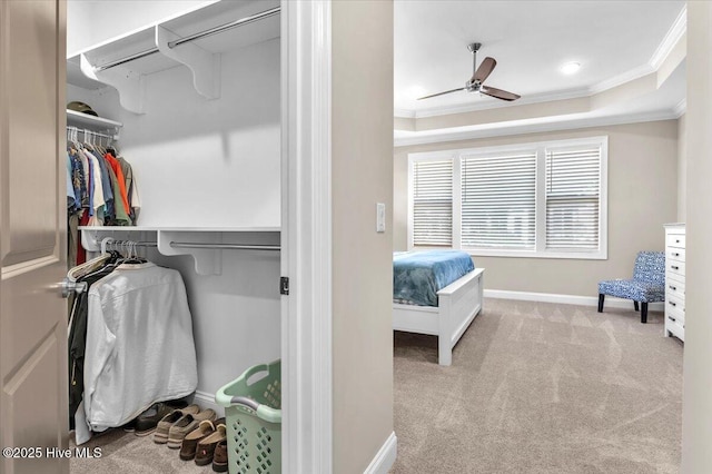 interior space with light colored carpet, ceiling fan, and a tray ceiling