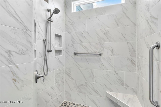 bathroom with tiled shower