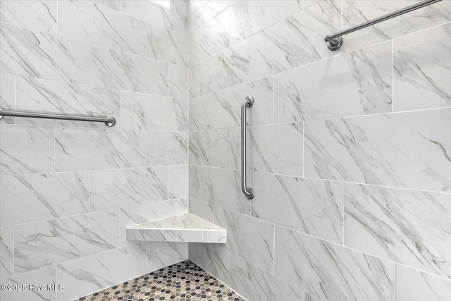 bathroom with a tile shower