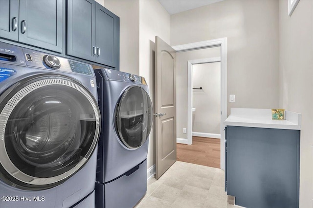 washroom with cabinets and separate washer and dryer