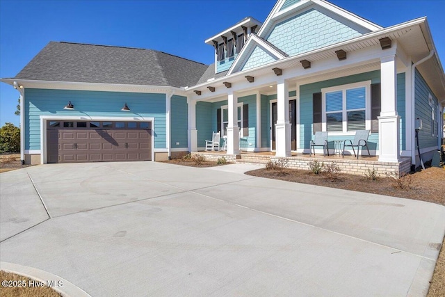 view of front of property featuring a garage and covered porch