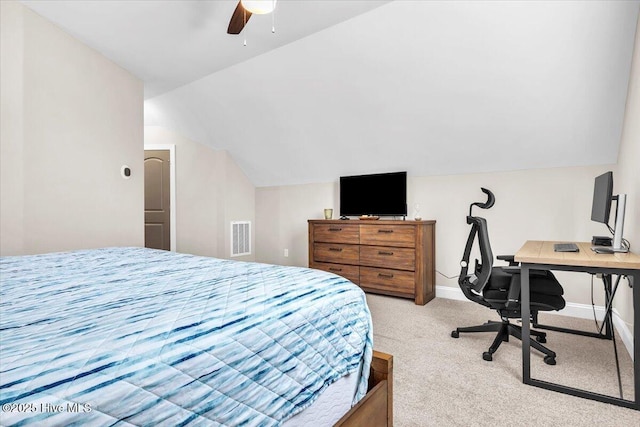 carpeted bedroom with ceiling fan and vaulted ceiling