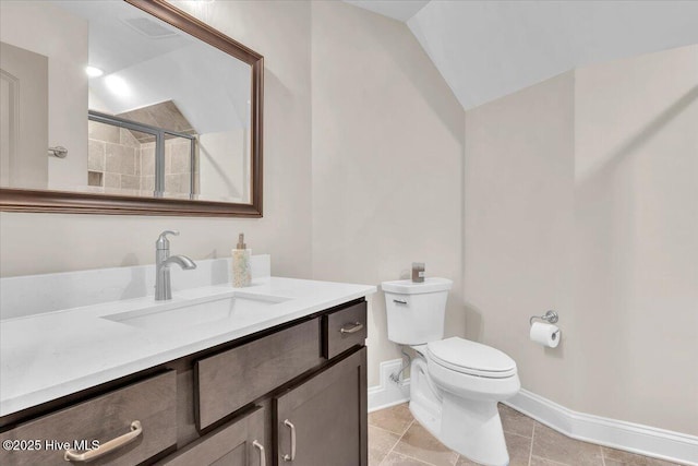 bathroom featuring vanity, vaulted ceiling, walk in shower, and toilet