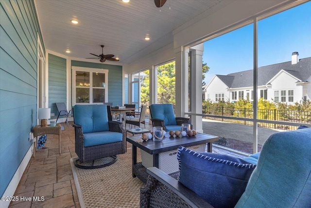 sunroom with ceiling fan and wooden ceiling