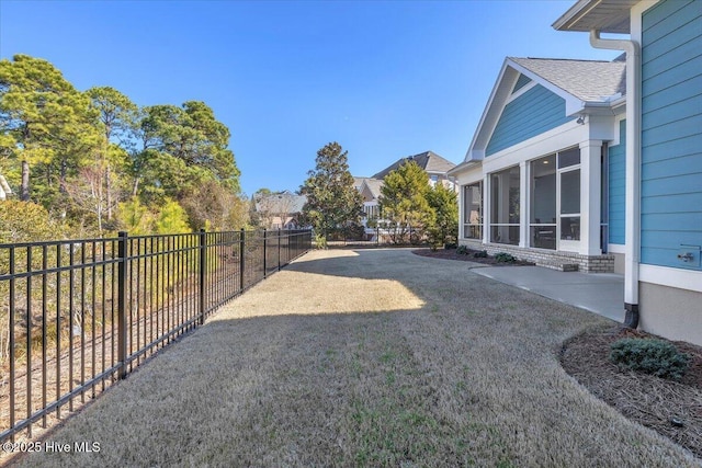 view of yard featuring a patio and a sunroom