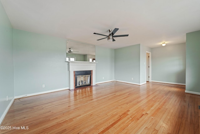 unfurnished living room featuring ceiling fan and light wood-type flooring