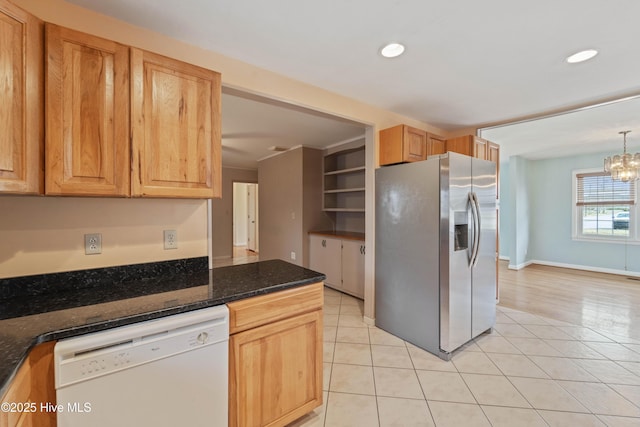 kitchen featuring light tile patterned flooring, decorative light fixtures, dark stone countertops, white dishwasher, and stainless steel refrigerator with ice dispenser