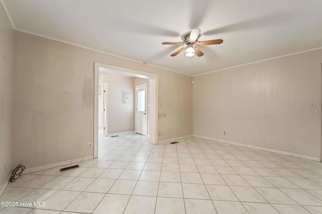 tiled empty room with crown molding and ceiling fan