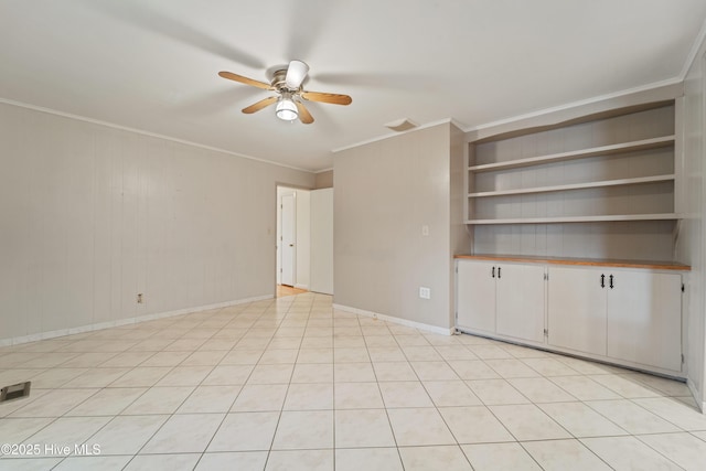 unfurnished living room featuring built in shelves, ceiling fan, and ornamental molding